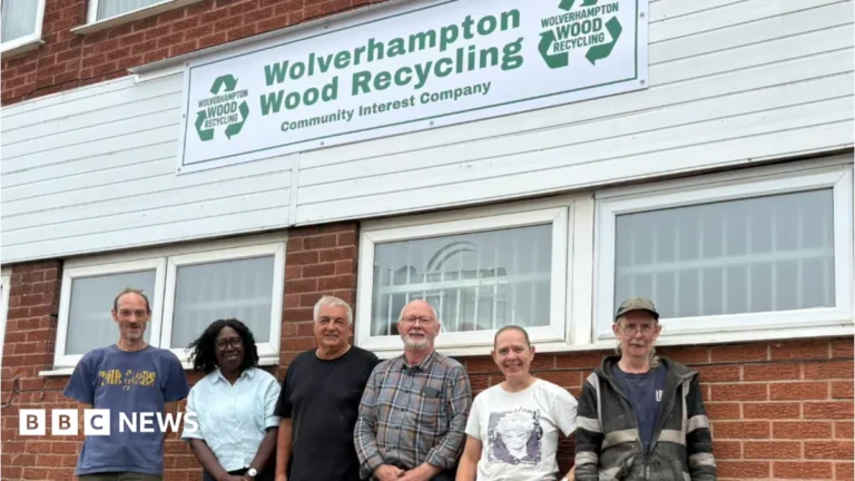 Volunteers at Wolverhampton Wood Recycling handling reclaimed wood at its new premises