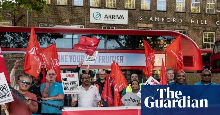 London bus driver sitting in a cab during hot weather while strike action continues
