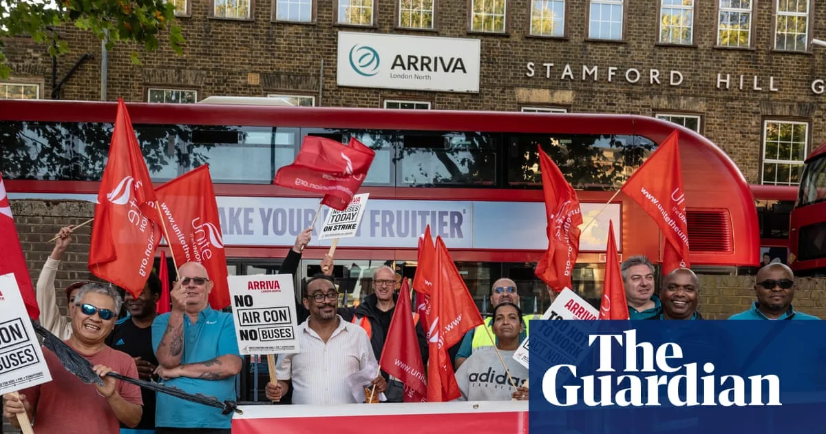 London bus driver sitting in a cab during hot weather while strike action continues