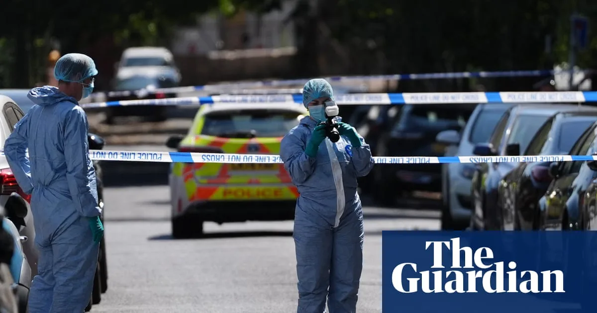 Police tape and emergency lights at a London street crime scene