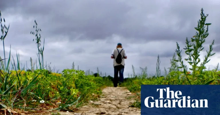 Rain falling on dry ground during a UK drought with water restrictions in place
