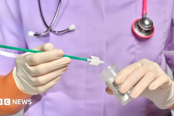 A woman holding a home HPV self-testing kit for cervical screening