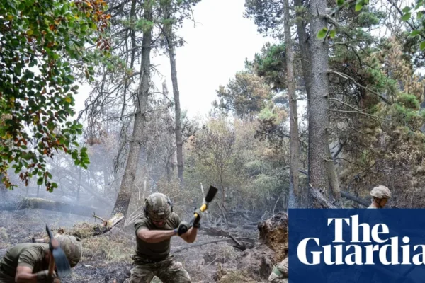 Firefighters and soldiers working on a smoke-blackened hillside near Blaenavon