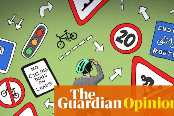 Cyclists and vehicles sharing a busy London street with traffic lights and marked lanes