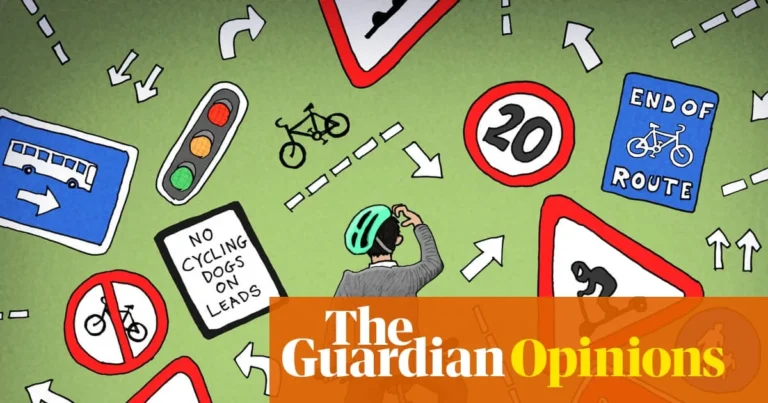Cyclists and vehicles sharing a busy London street with traffic lights and marked lanes