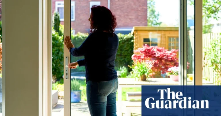 A locksmith fitting a door lock as hot weather causes doors to jam and misalign
