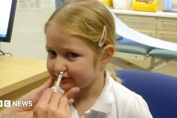 A nurse preparing a flu vaccine for an NHS autumn vaccination campaign