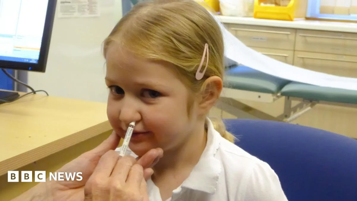 A nurse preparing a flu vaccine for an NHS autumn vaccination campaign