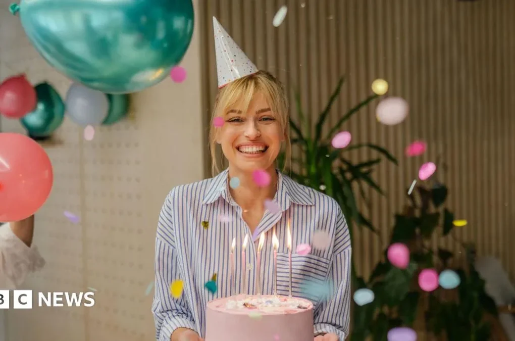 Birthday loyalty app offers on a phone alongside coffee, cake and restaurant vouchers