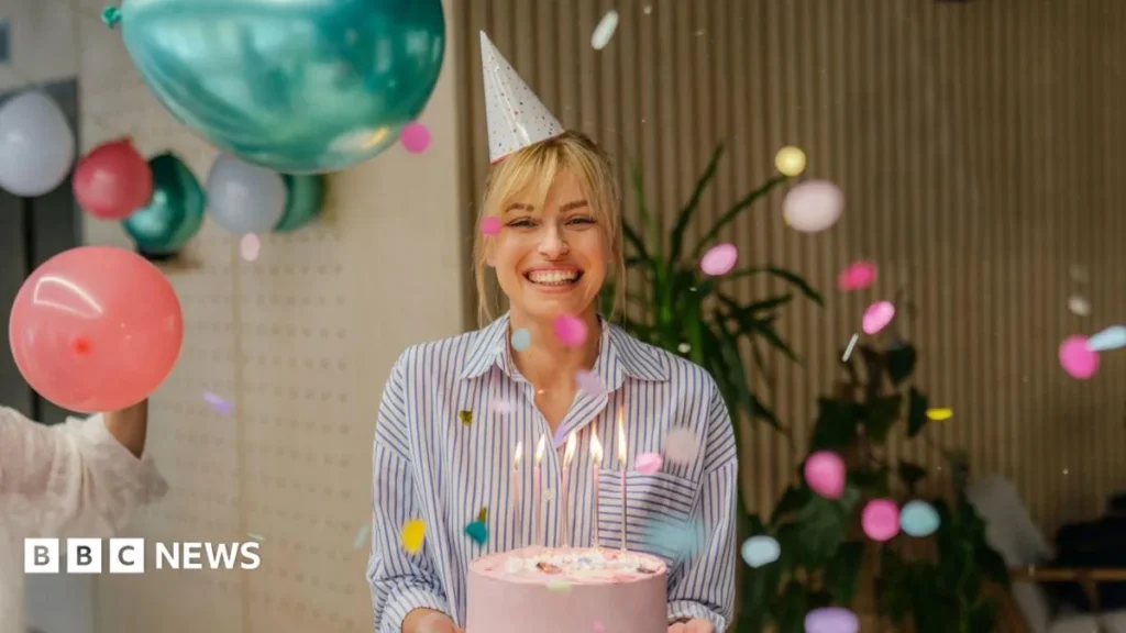 Birthday loyalty app offers on a phone alongside coffee, cake and restaurant vouchers