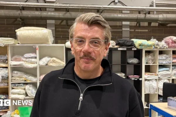 Stacked new mattresses inside Care Zone's Peterborough warehouse ready for families