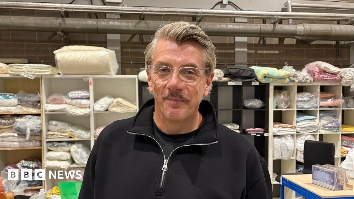 Stacked new mattresses inside Care Zone's Peterborough warehouse ready for families